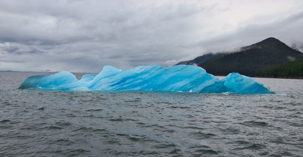 Large iceberg floating in the water.